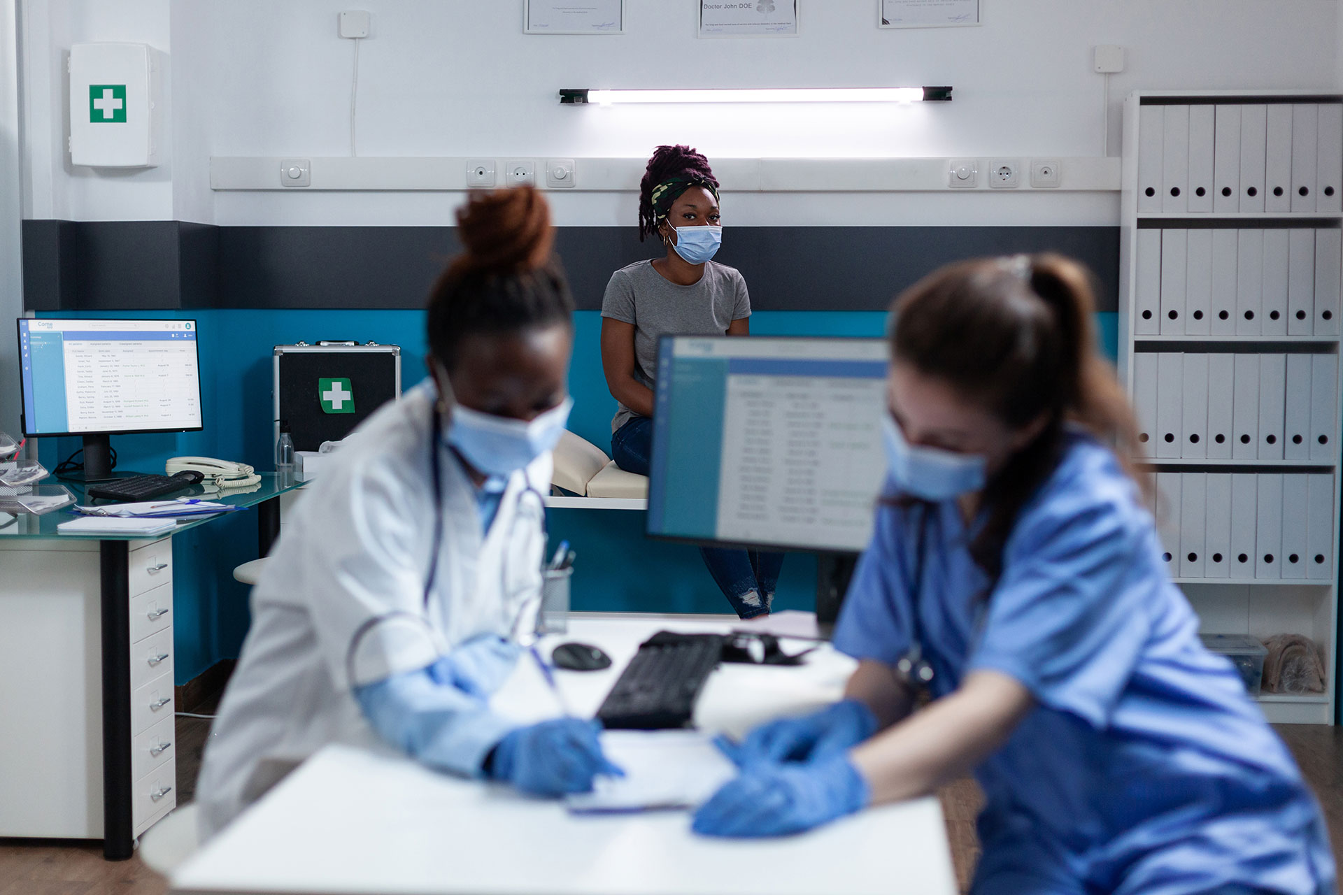 medical-team-with-protective-face-mask-prevent-infection-with-covid19-analyzing-medication-documents-working-hospital-office-african-am